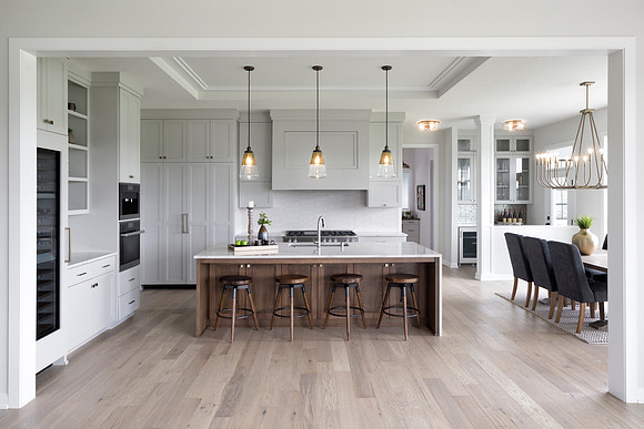 Open kitchen with Cambria waterfall island and dining area nook