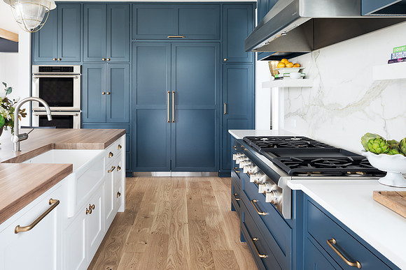 Kitchen with painted cabinets and marble backsplash